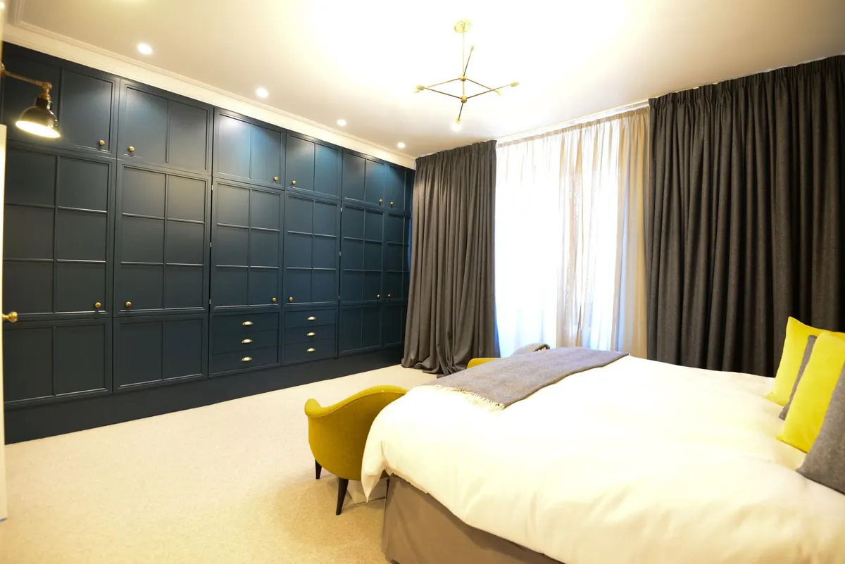 Bedroom with panelled wall