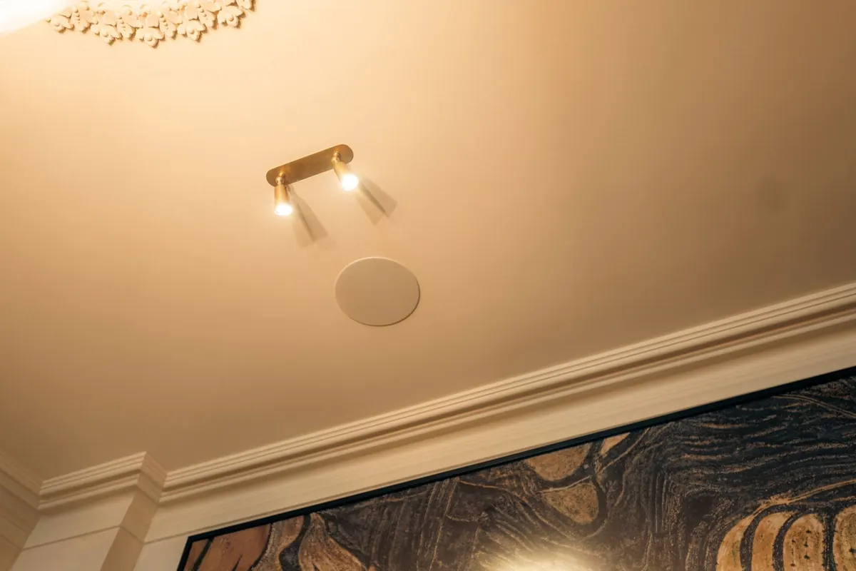 In-ceiling speaker beside the picture lights