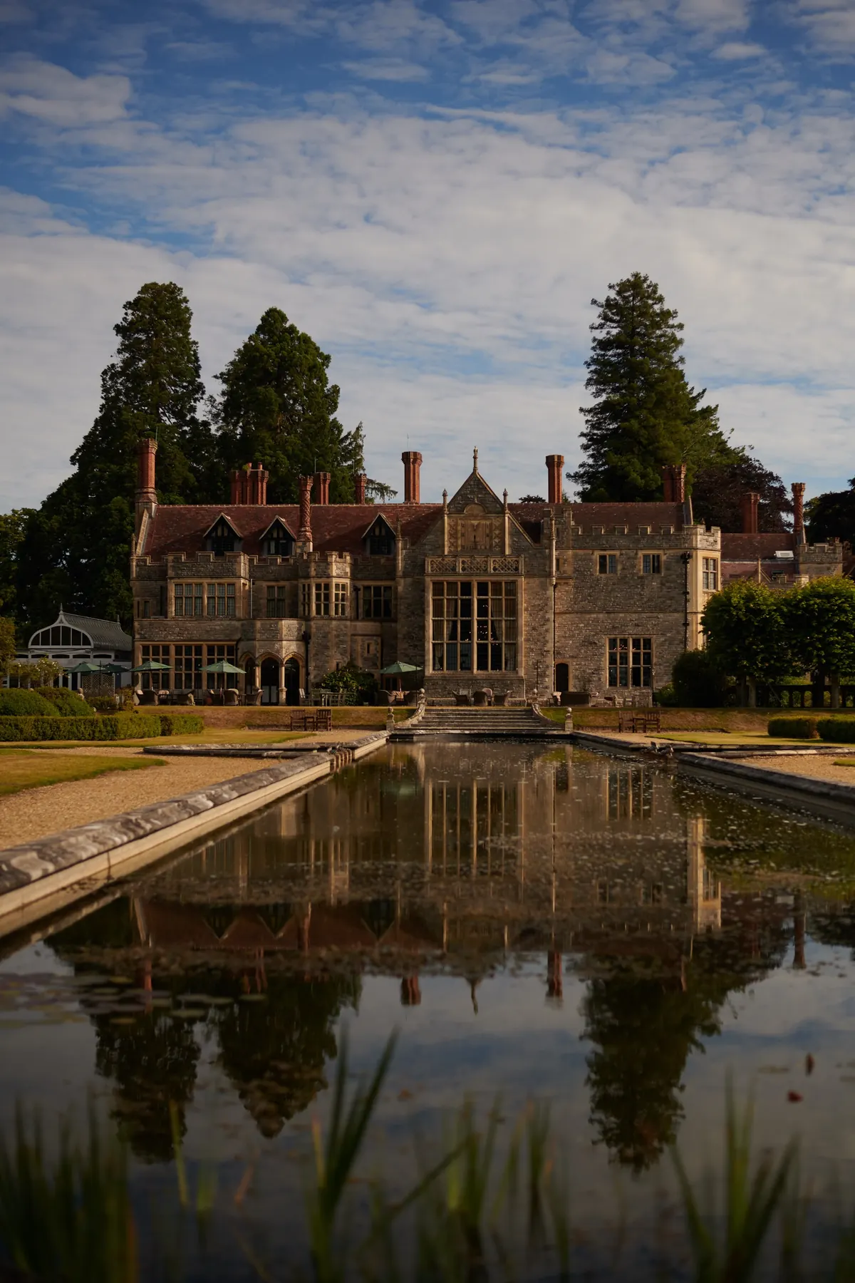 Country house hotel reflected in its formal pool